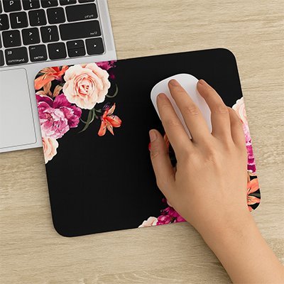 tapis souris floral avec main dirigeant souris et ordinateur sur surface bois